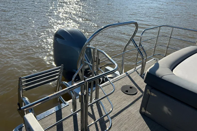 Slide: The Image of 2022 Godfrey Sweetwater 2286 C boat with motor and seating, on water. - 17