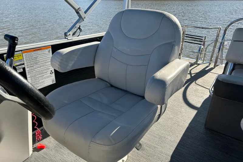 Slide: The Image of Captain's chair on 2022 Godfrey Sweetwater 2286 C pontoon boat, overlooking water. - 19
