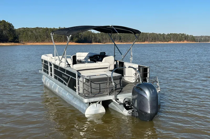 Slide: The Image of 2022 Godfrey Sweetwater 2286 C pontoon boat on a serene lake. - 4
