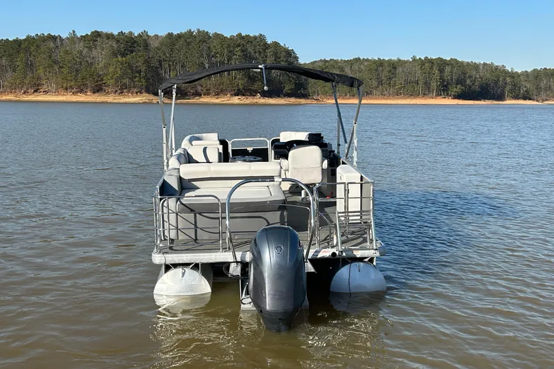 Slide: The Image of 2022 Godfrey Sweetwater 2286 C pontoon boat on a serene lake. - 5