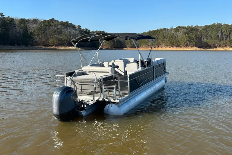 Slide: The Image of 2022 Godfrey Sweetwater 2286 C pontoon boat on a serene lake. - 6