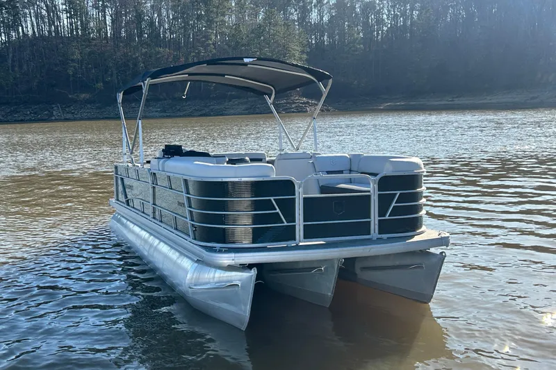 Slide: The Image of 2022 Godfrey Sweetwater 2286 C pontoon boat on a calm lake. - 9