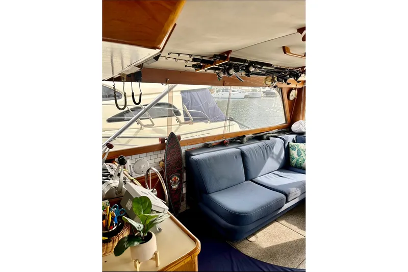 Slide: The Image of Interior of 1987 Egg Harbor 43 Sport Fisherman with blue seating and fishing rods. - 16