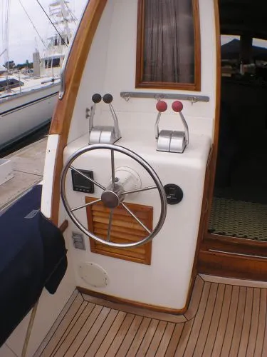 Slide: The Image of 1987 Egg Harbor Sportfisher interior with fishing gear, TV, and cozy wooden decor. - 19