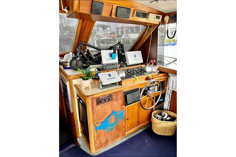Slide: The Image of 1987 Egg Harbor 43 Sport Fisherman helm with navigation equipment and wooden dashboard. - 22