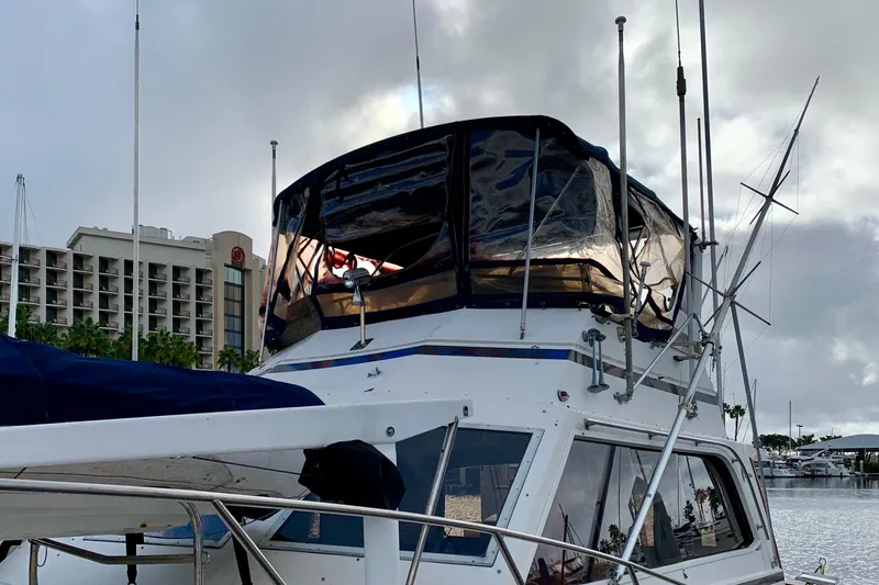 Slide: The Image of 1987 Egg Harbor 43 Sport Fisherman boat docked at marina, cloudy sky background. - 23