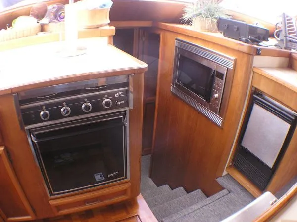 Slide: The Image of Two people fishing on a 1987 Egg Harbor Sportfisher boat. - 28