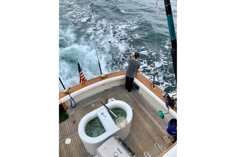 Slide: The Image of Person fishing on 1987 Egg Harbor 43 Sport Fisherman boat at sea. - 29