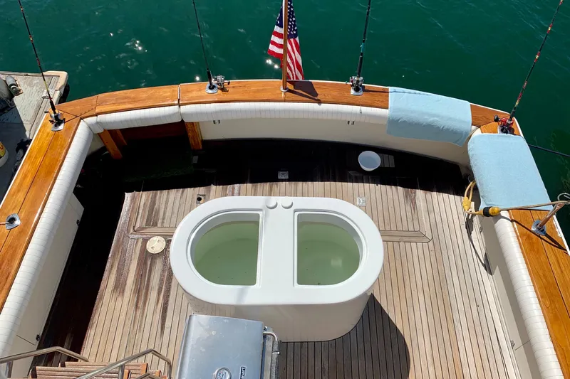 Slide: The Image of 1987 Egg Harbor 43 Sport Fisherman deck with fishing rods and American flag. - 3