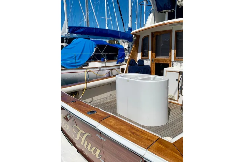 Slide: The Image of 1987 Egg Harbor 43 Sport Fisherman boat with wooden deck and white storage unit. - 4