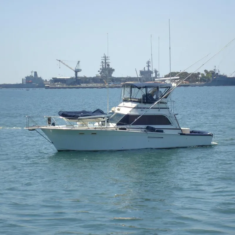 The Image of 1987 Egg Harbor Sportfisher boat on water with industrial background. - 0