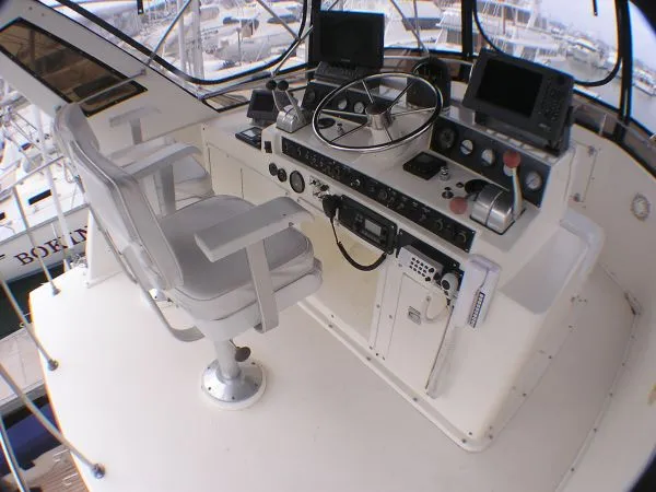 Slide: The Image of Interior of a 1987 Egg Harbor Sportfisher boat with laptop and cozy seating. - 10