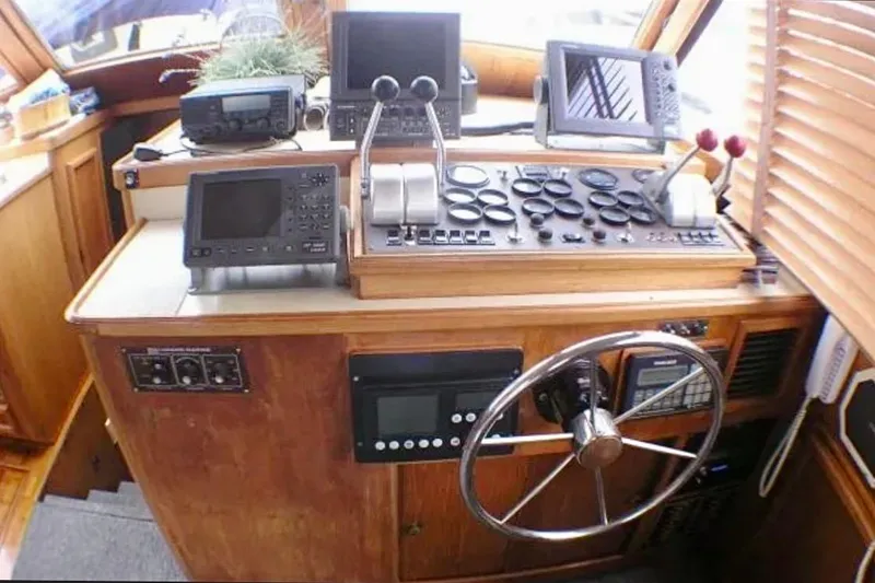Slide: The Image of 1987 Egg Harbor Sportfisher helm with navigation equipment and steering wheel. - 15