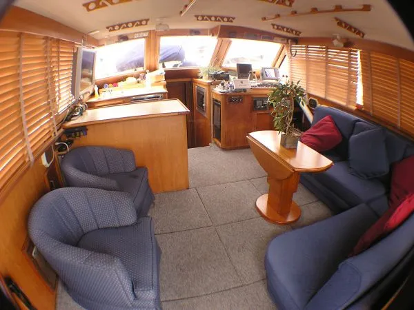 Slide: The Image of 1987 Egg Harbor Sportfisher yacht docked at night with illuminated blue lights. - 3