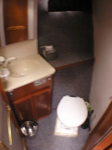 Slide: The Image of 1987 Egg Harbor Sportfisher boat interior with fishing equipment and ladder at night. - 8