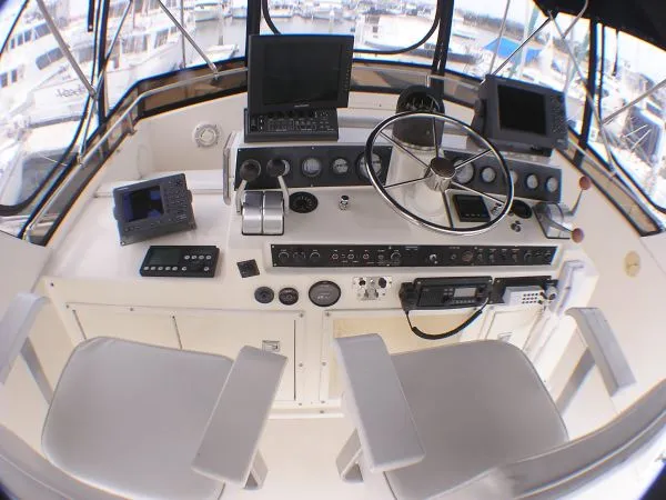 Slide: The Image of 1987 Egg Harbor Sportfisher boat illuminated at night in a marina. - 9