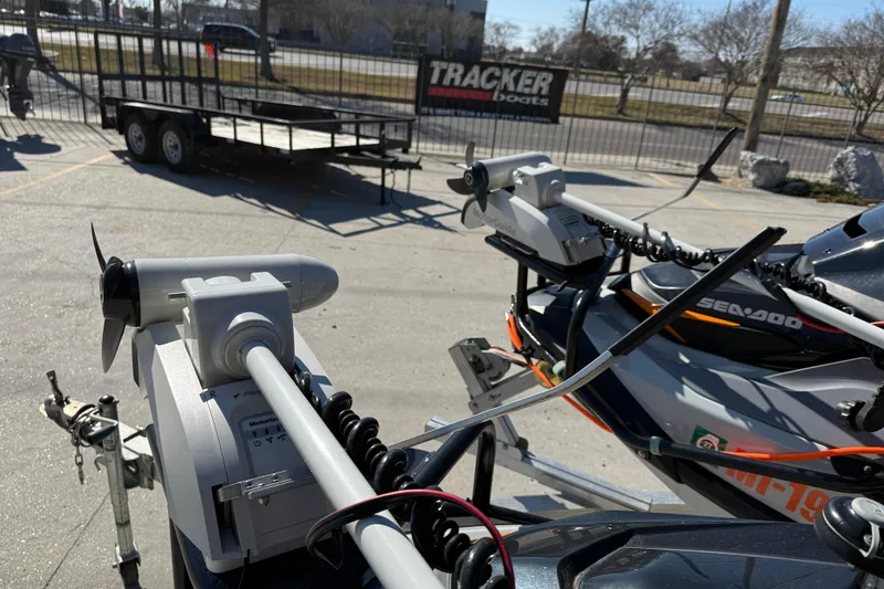 Slide: The Image of 2024 Sea-Doo FishPro Trophy 170 with mounted trolling motors in a parking lot. - 11