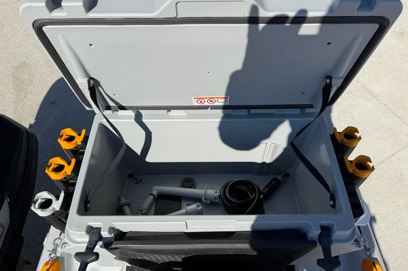 Slide: The Image of Open storage compartment of 2024 Sea-Doo FishPro Trophy 170 with fishing accessories. - 16