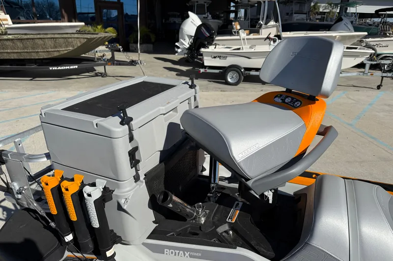 Slide: The Image of 2024 Sea-Doo FishPro Trophy 170 with fishing gear and seating, docked at a marina. - 17