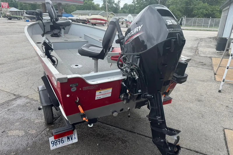 Slide: The Image of 2023 Lund 1600 Fury Tiller boat with Mercury outboard motor, parked on a trailer. - 8