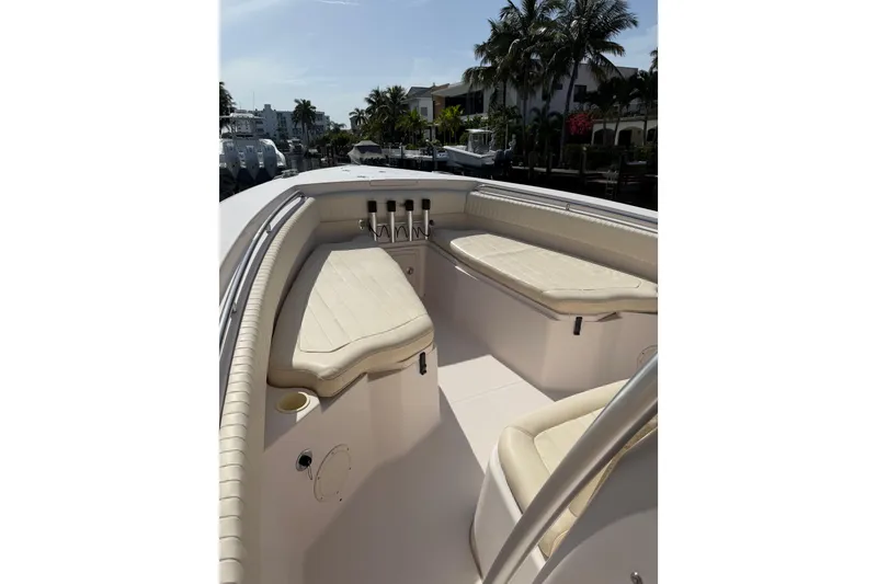 Slide: The Image of 2006 Grady-White Bimini 306 boat interior with cushioned seating and rod holders. - 21