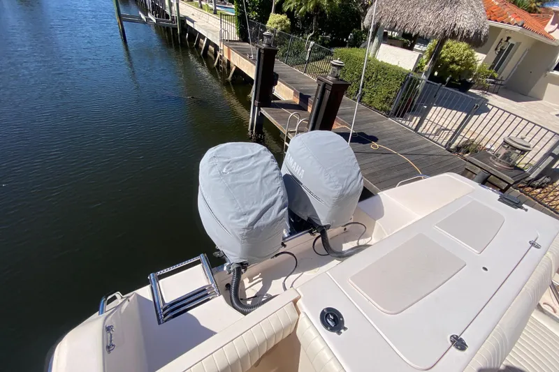 Slide: The Image of 2006 Grady-White Bimini 306 boat interior with seating and fishing rod holders. - 10