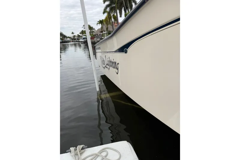 Slide: The Image of 2006 Grady-White Bimini 306 boat docked by waterfront homes. - 12