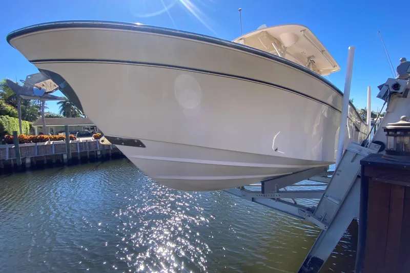 Slide: The Image of 2006 Grady-White Bimini 306 boat docked near waterfront, sunny day. - 14