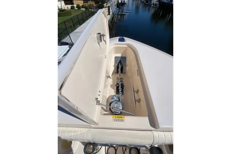 Slide: The Image of 2006 Grady-White Bimini 306 anchor locker with chain and winch, dockside view. - 17