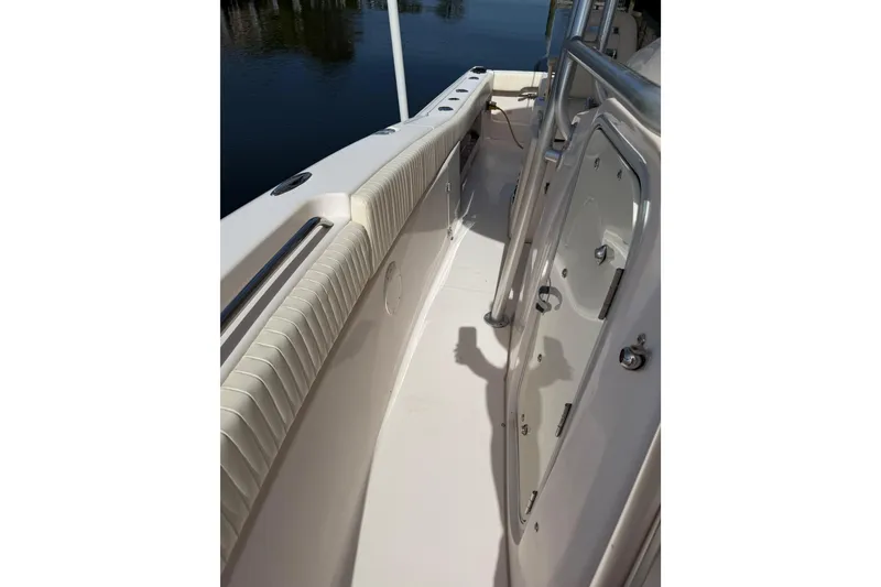 Slide: The Image of 2006 Grady-White Bimini 306 boat interior with cushioned seating and stainless steel railings. - 19