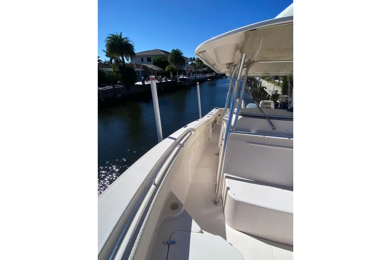 Slide: The Image of 2006 Grady-White Bimini 306 boat docked on a sunny canal. - 21