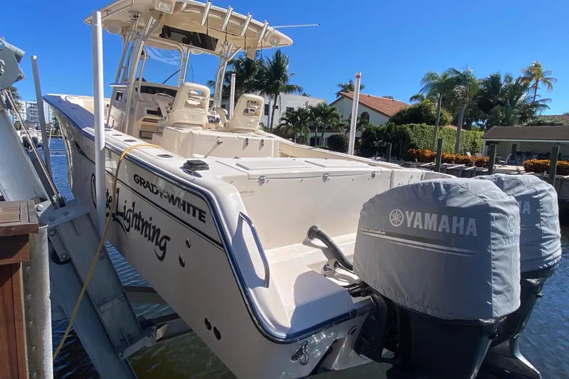 Slide: The Image of 2006 Grady-White Bimini 306 boat with Yamaha engines docked by waterfront homes. - 23