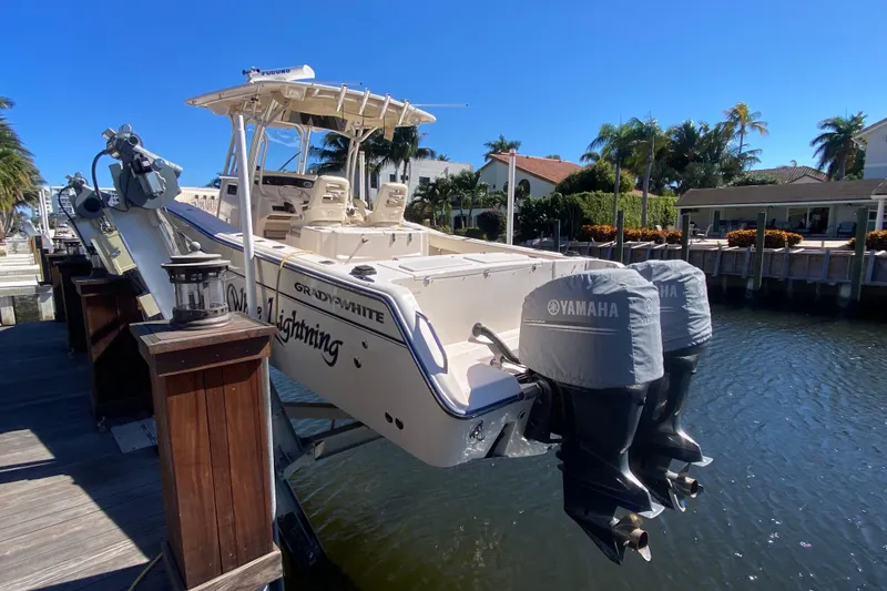 Slide: The Image of 2006 Grady-White Bimini 306 boat docked, featuring Yamaha engines, sunny waterfront setting. - 24