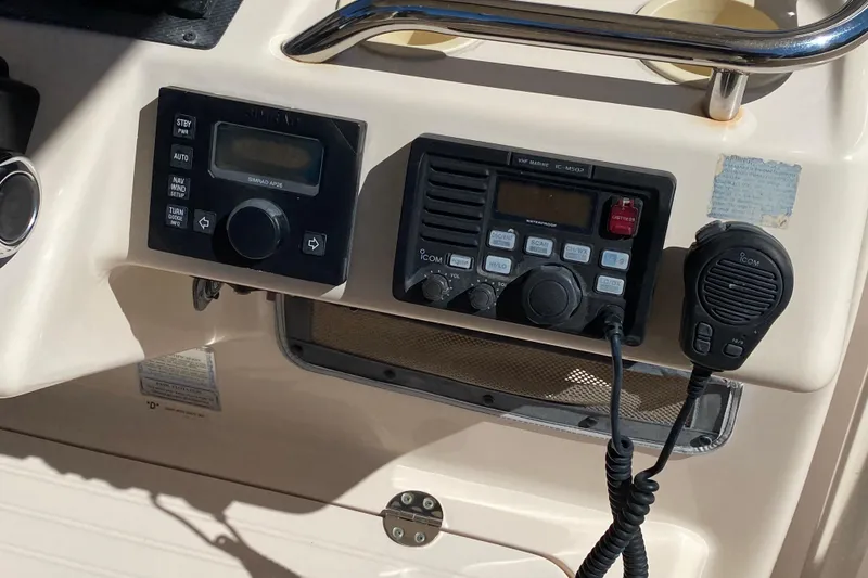 Slide: The Image of 2006 Grady-White Bimini 306 boat on lift, sunny waterfront view. - 3