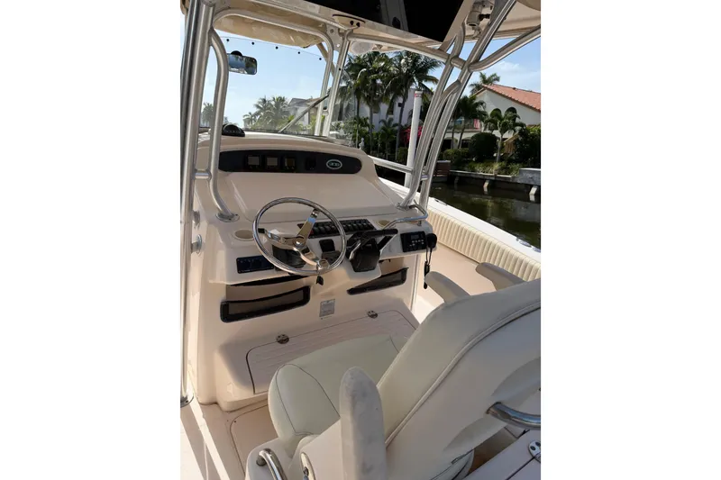 Slide: The Image of 2006 Grady-White Bimini 306 boat interior with steering wheel and seating. - 25