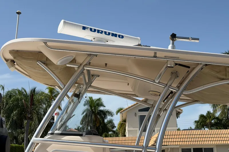 Slide: The Image of 2006 Grady-White Bimini 306 boat with radar equipment, featuring a sturdy T-top design. - 23