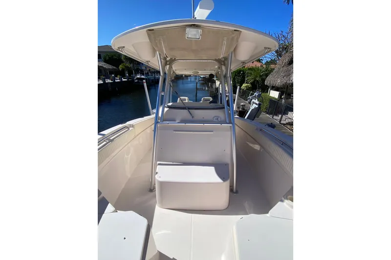 Slide: The Image of 2006 Grady-White Bimini 306 boat console storage with radio equipment, sunny day. - 6