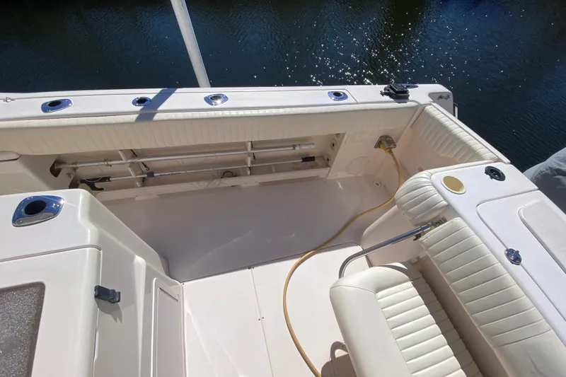 Slide: The Image of 2006 Grady-White Bimini 306 boat interior with helm and seating under clear blue sky. - 9