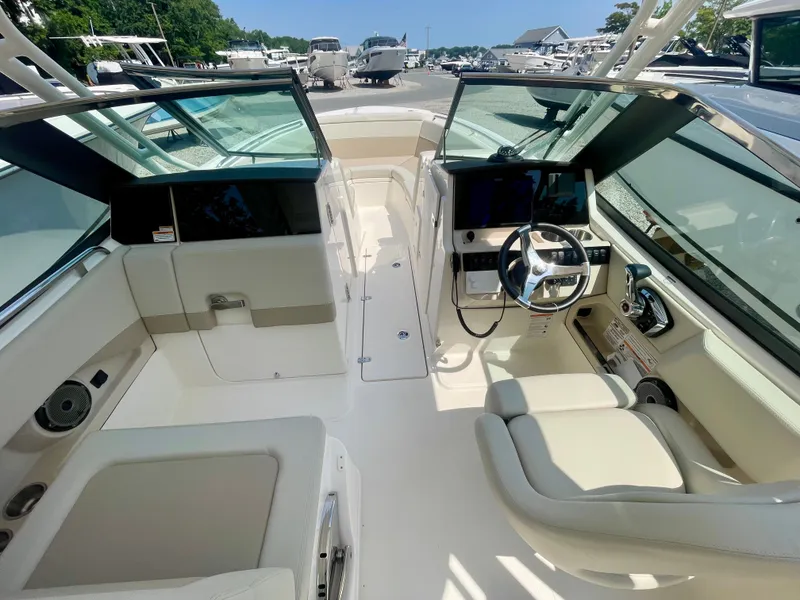 Slide: The Image of The image shows the cockpit of a Boston Whaler 240 Vantage with modern seating and controls. - 13