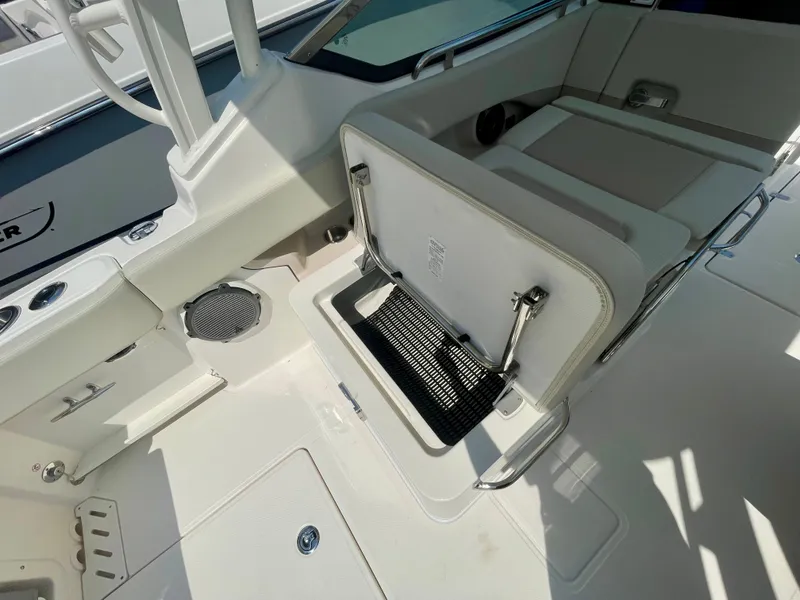 Slide: The Image of Interior view of a Boston Whaler 240 Vantage with seating and storage area. - 8