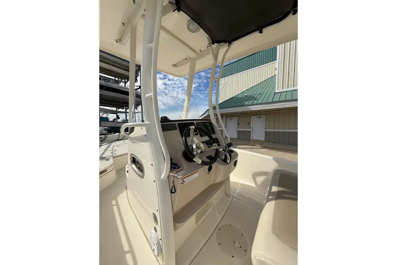 Slide: The Image of 2020 Boston Whaler 240 Dauntless boat interior with steering console and seating. - 13