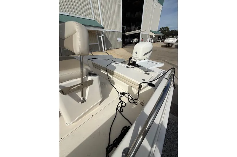 Slide: The Image of 2020 Boston Whaler 240 Dauntless boat with Mercury engine, docked near storage facility. - 14