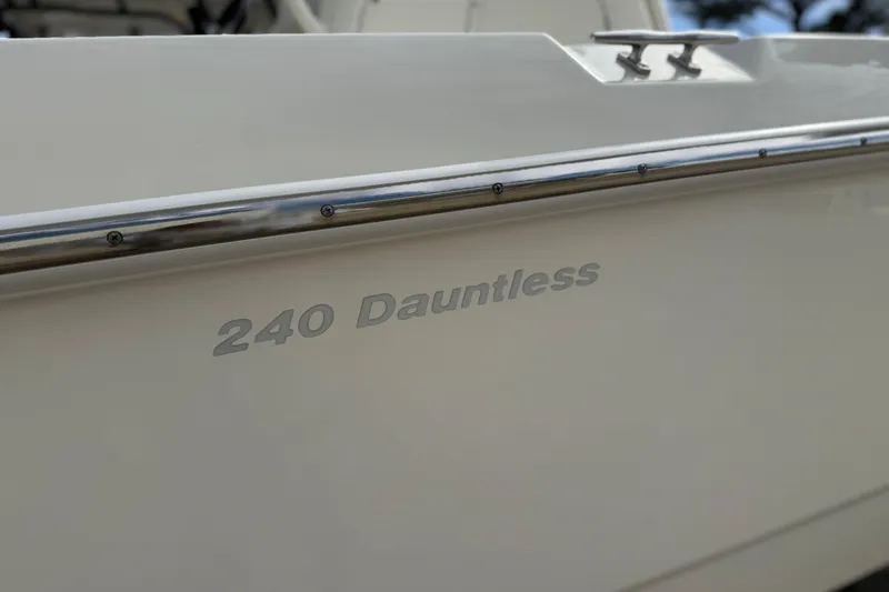 Slide: The Image of 2020 Boston Whaler 240 Dauntless boat side view with model name visible. - 6
