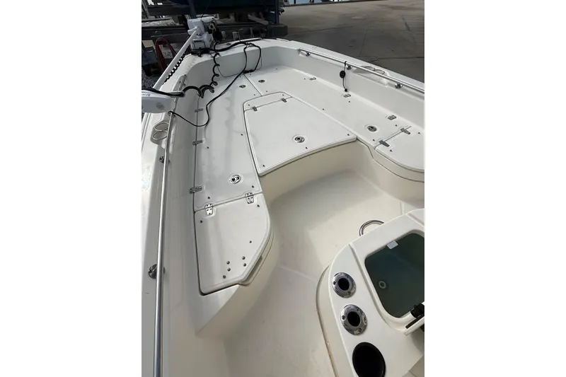 Slide: The Image of 2020 Boston Whaler 240 Dauntless boat deck with storage compartments and fishing rod holders. - 7