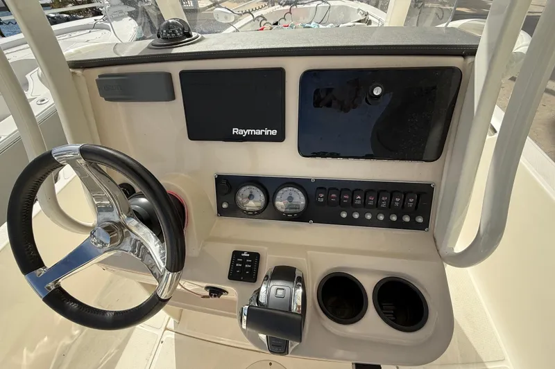 Slide: The Image of 2020 Boston Whaler 240 Dauntless boat dashboard with steering wheel and Raymarine display. - 9
