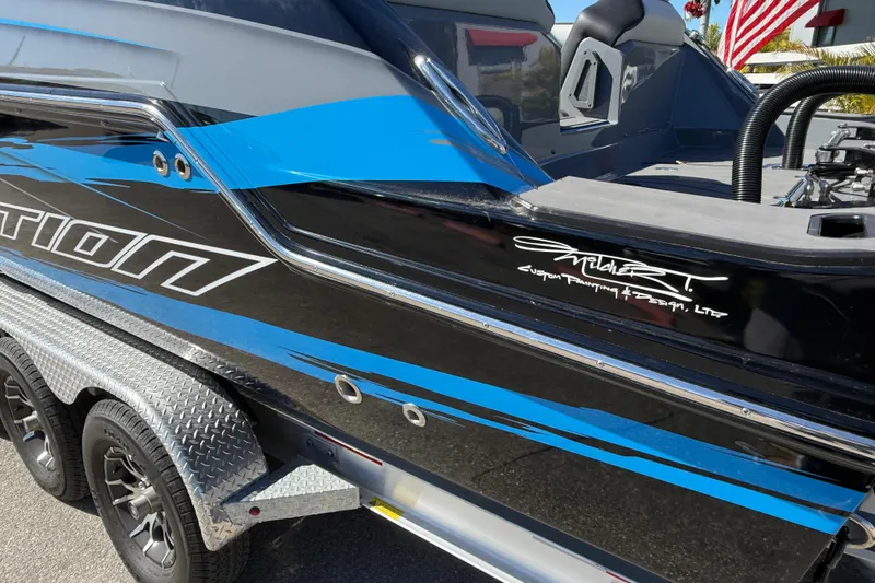 Slide: The Image of 2026 Sunsation 32 CCX boat with custom blue and black design on trailer. - 10