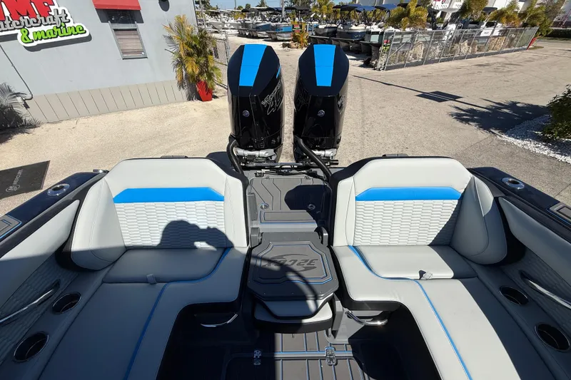 Slide: The Image of 2026 Sunsation 32 CCX boat interior with dual engines, featuring blue and gray seating. - 19