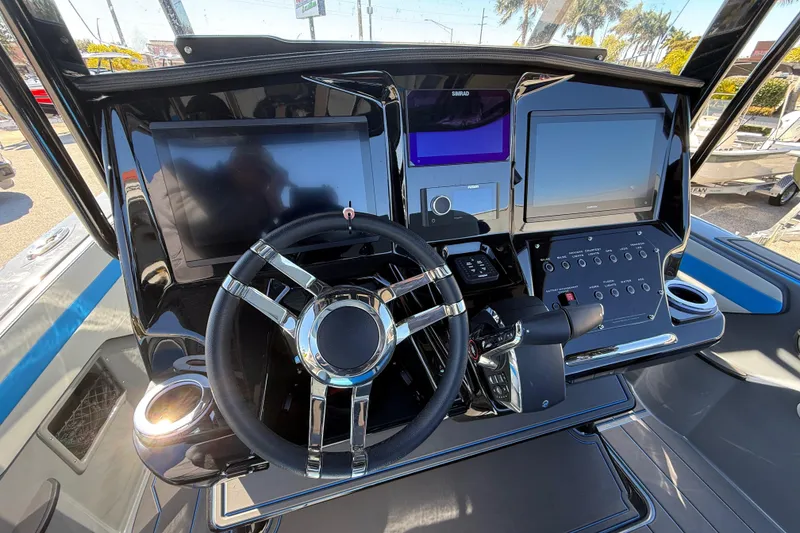 Slide: The Image of 2026 Sunsation 32 CCX boat dashboard with modern controls and steering wheel. - 23