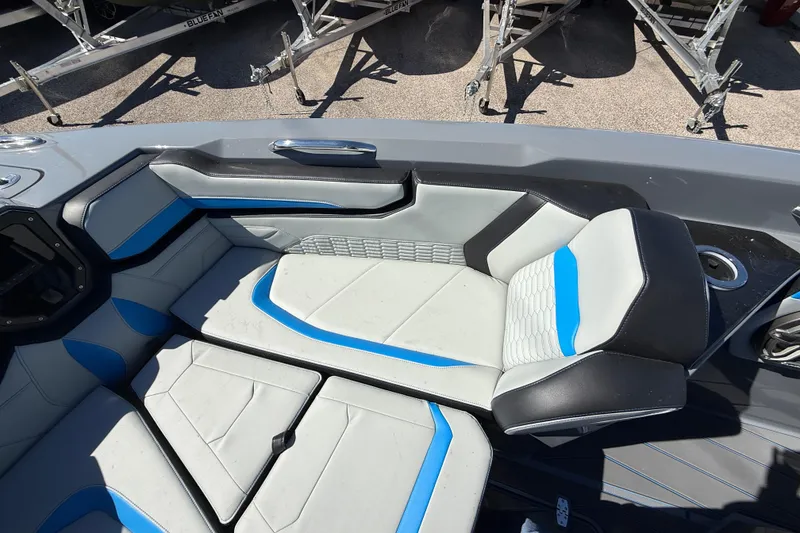 Slide: The Image of 2026 Sunsation 32 CCX boat interior with modern seating and blue accents. - 32