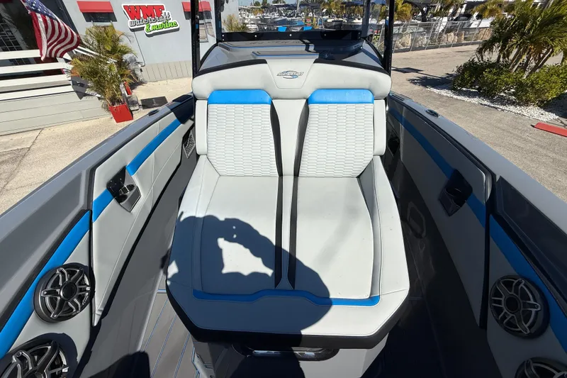 Slide: The Image of 2026 Sunsation 32 CCX boat interior with blue and white seating, docked outdoors. - 34